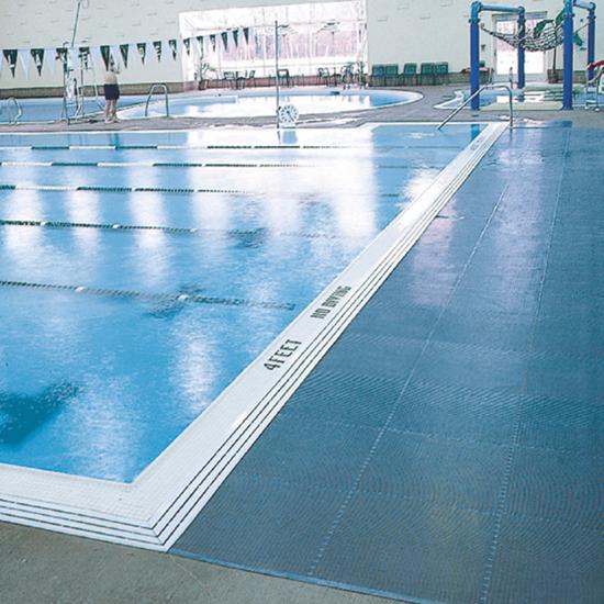 Non slip poolside mats laid across a commercial swimming pool deck