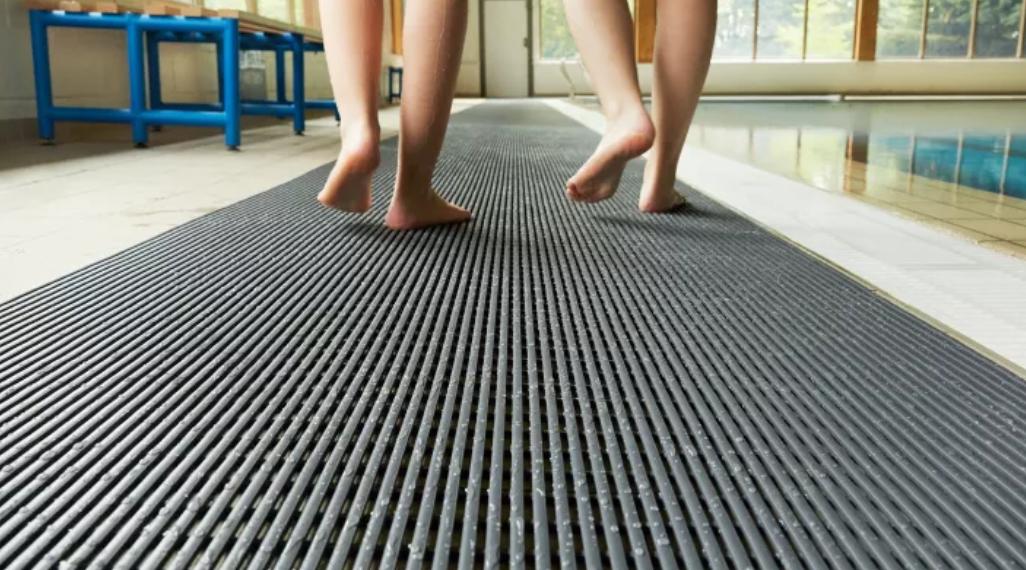 Open-grid drainage matting keeping a wet commercial floor slip resistant