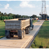 Composite temporary road mat panel interlocked into an access lane across soft ground
