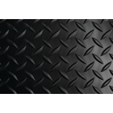Gray diamond plate vinyl runner matting with raised embossed tread laid across a service bay floor