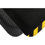 Black nitrile rubber anti-fatigue kitchen mat with sloped edges at a commercial prep station