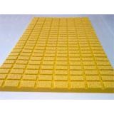 Yellow polyurethane rotary table mat with raised grid traction surface and molded drainage channels