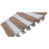 Rigid recessed aluminum entrance grate seated flush in a deep floor pit
