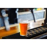 Custom-printed rubber drink mat with a company logo on a bar counter