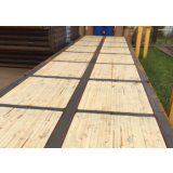 Steel-framed laminated timber rig mat forming a load-bearing platform on an oilfield location