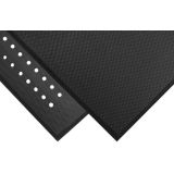 Black Traction Hog anti-fatigue runner mat with drainage holes and beveled edges along a commercial kitchen line