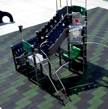 Rubber playground safety tiles installed under play equipment to provide impact absorption and fall protection.